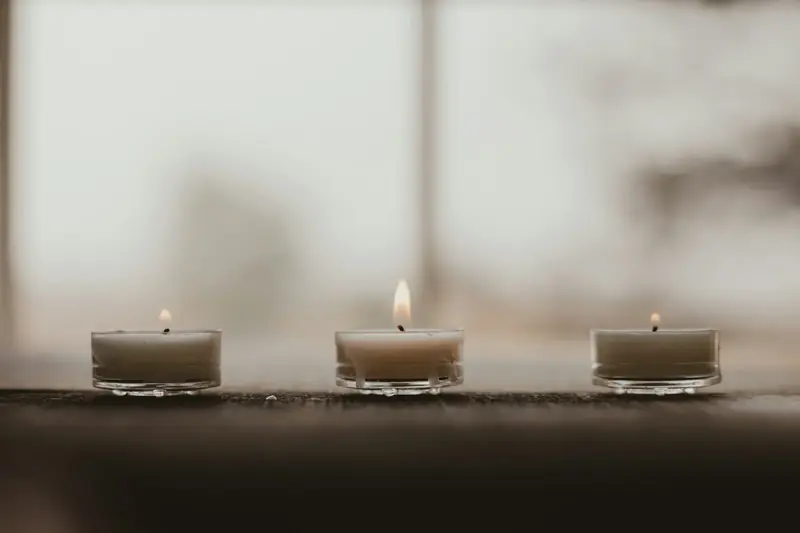 White memorial candles by a window — Sioux Falls wrongful death lawyer